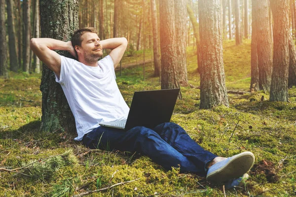 Jonge Man Met Laptop Leunend Tegen Boom Ontspannen Het Park — Stockfoto