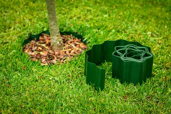 Green Plastic Lawn Edge Tape Flowerbed Tree Edging — Stock Photo, Image