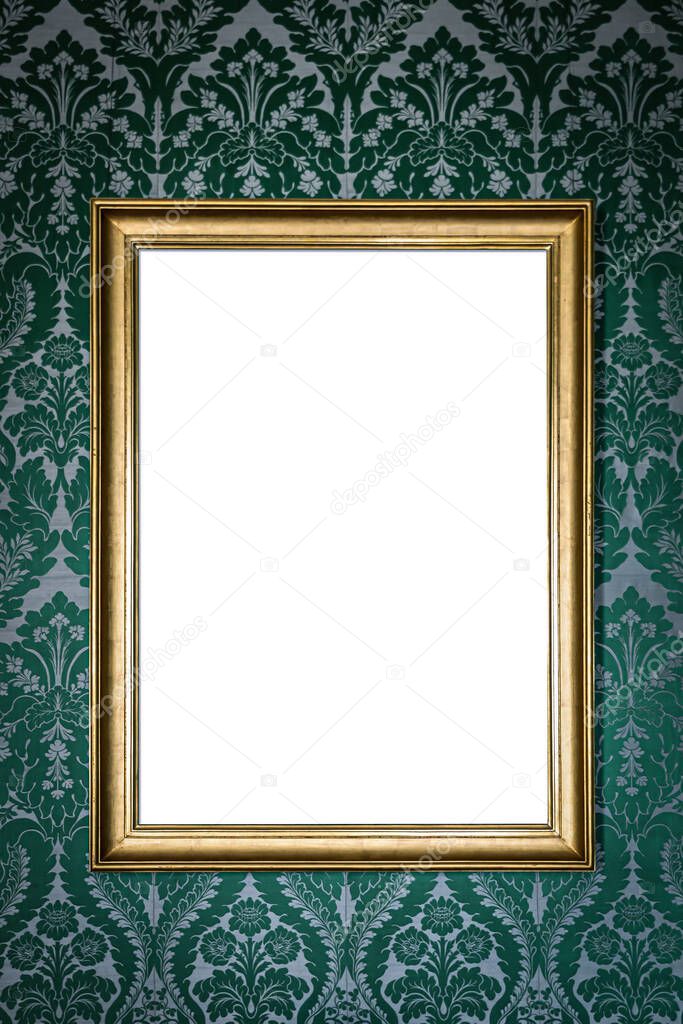 blank golden picture frame hanging on wall on green floral vintage wallpaper