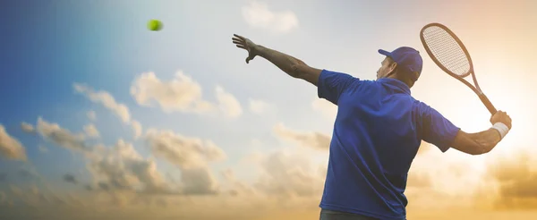 Tennisprofi Blauem Hemd Schlägt Ball Mit Schläger Vor Sonnenuntergang Himmel — Stockfoto