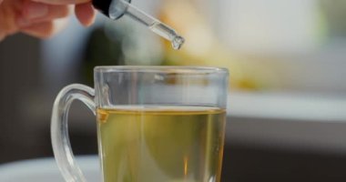 Beslenme takviyeleri ve vitaminler - bir fincan damlatıcıyla çay ilave edilir