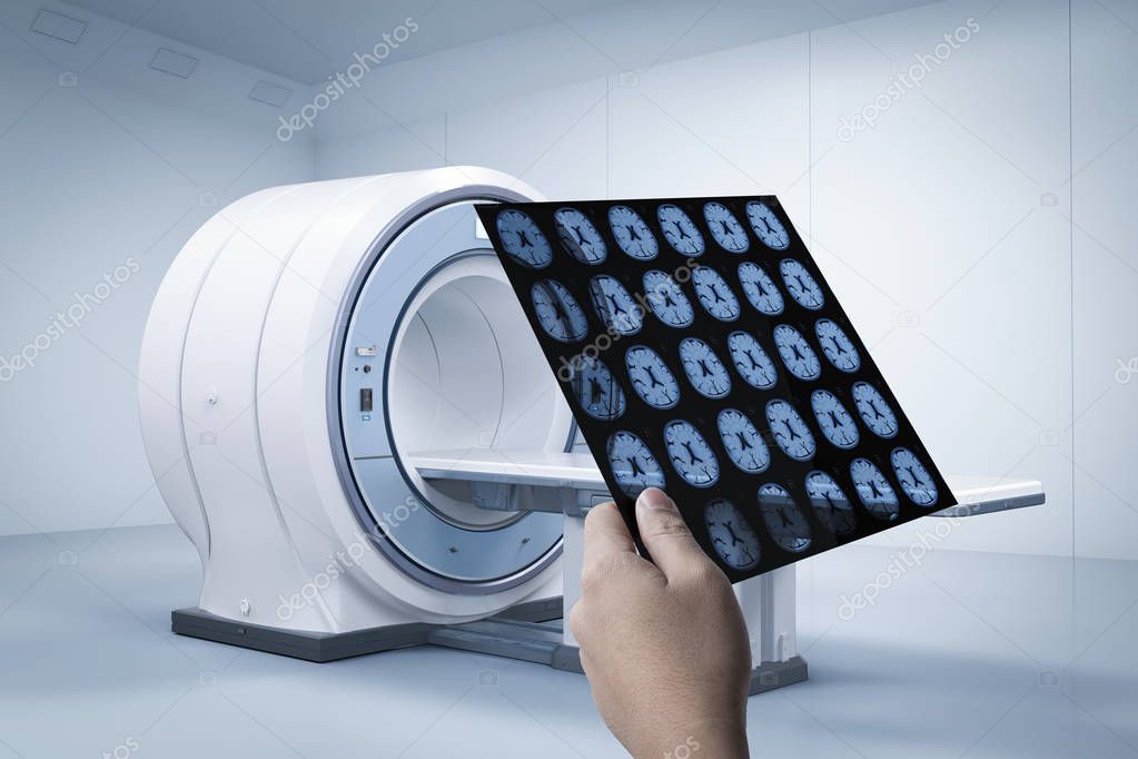 Hand holding x-ray film with 3d rendering mri scan machine or magnetic resonance imaging scan devic