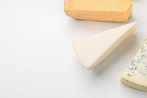 A large variety of cheeses triangles  on an white backgroud