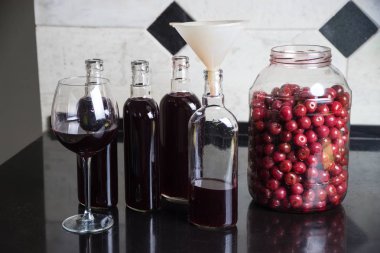 Homemade tincture of cherry. The concept of home-made drinks. clipart