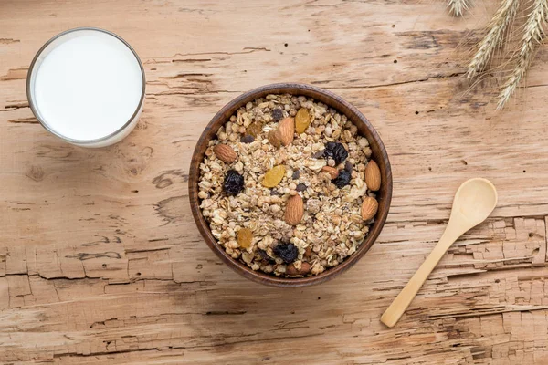 Breakfast with Granola Bowl, Muesli with Oats, Nuts and Dried Fruit, Milk, on Wooden table.  Healthy Breakfast. Diet. Top view.