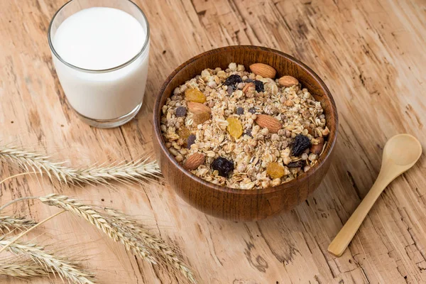 Breakfast with Granola Bowl, Muesli with Oats, Nuts and Dried Fruit, Milk, on Wooden table.  Healthy Breakfast. Diet.