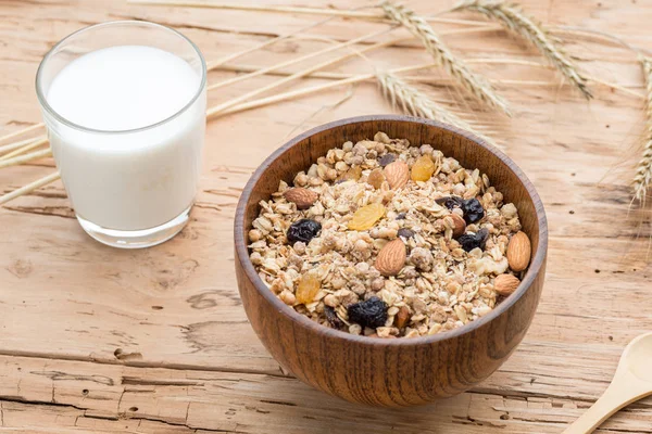 Breakfast with Granola Bowl, Muesli with Oats, Nuts and Dried Fruit, Milk, on Wooden table. Healthy Breakfast. Diet.