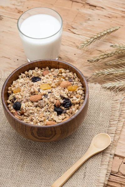 Breakfast with Granola Bowl, Muesli with Oats, Nuts and Dried Fruit, Milk, on Wooden table. Healthy Breakfast. Diet.