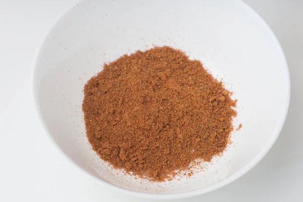 Chili powder in white bowl on white background — Stock Photo, Image