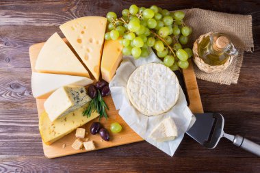 Ahşap arka plan üzerinde üzüm ile Peynir tabağı servis