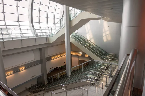 Image of large modern escalators for 4 way with staircase at air