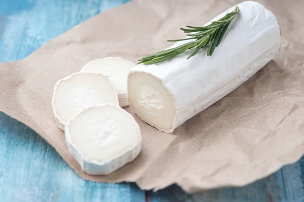 Formaggio di capra fresco con fette su carta . — Foto Stock