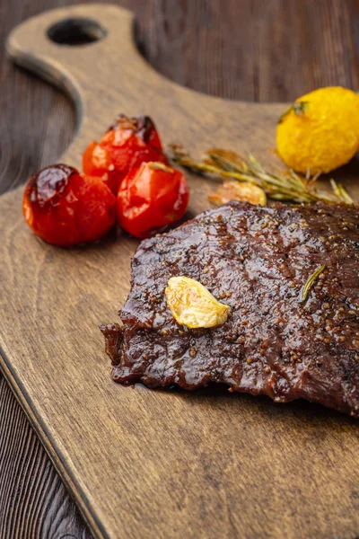 Grilled rib eye  steak with spices  served on a wooden board wit — Stock Photo, Image