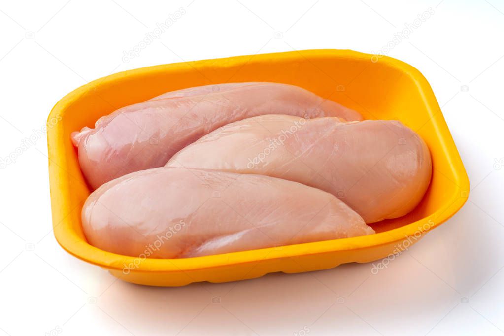 Raw chicken fillet package isolated on white background.