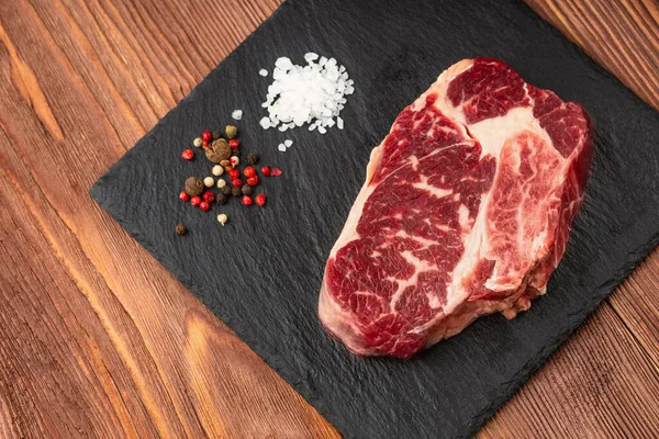 Fresh Raw Prime Black Angus Beef Steaks Stone Board Striploin Stock Photo