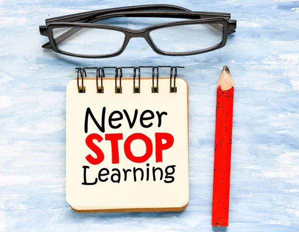 Never stop learning text concept, wooden background