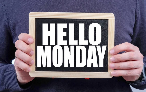 HELLO MONDAY. Hands holding blackboard with handwritten hello monday