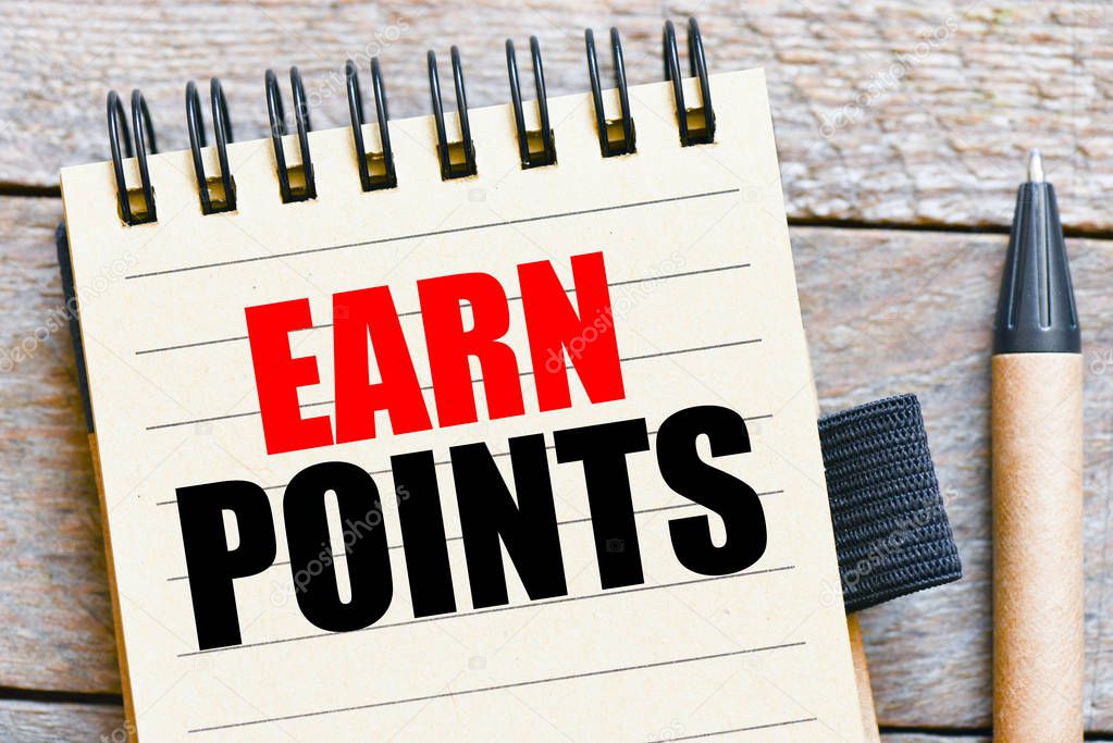 EARN POINTS inscription in notepad on table