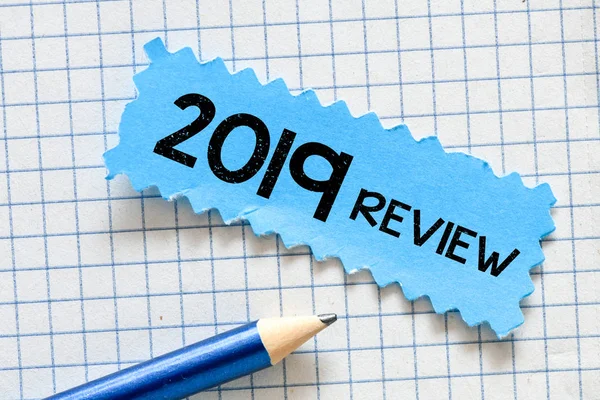 paper with 2019 review and blue pencil