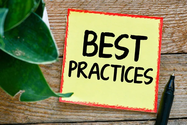 Best practices text concept. Paper with pen and potted plant on wooden table