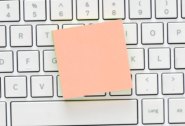 Colourful paper sheets on computer keyboard
