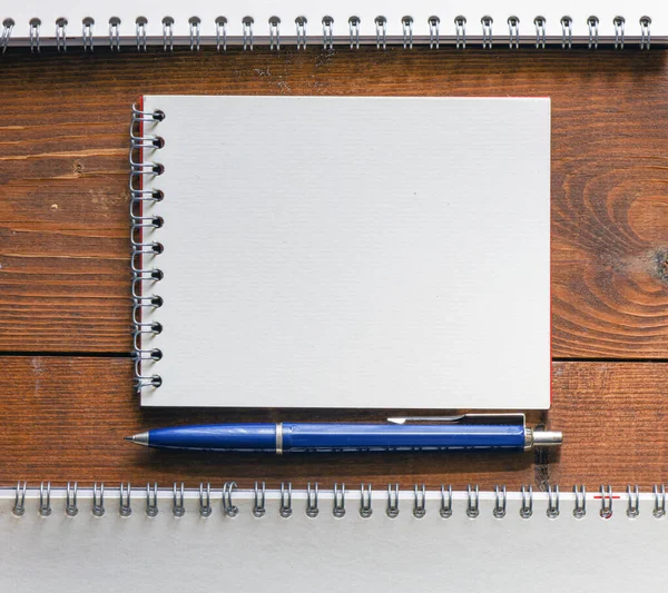 空白のメモ帳とオフィスの木製のテーブル — ストック写真