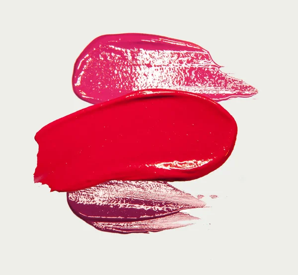 Smudged smeared lipstick stroke on white isolated background