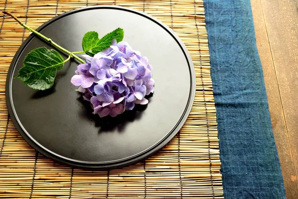 Purple hydrangea on black Japanese tray.