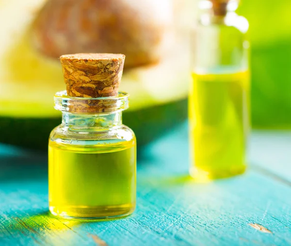 avocado oil cosmetics medicine health nature glass vial wooden background