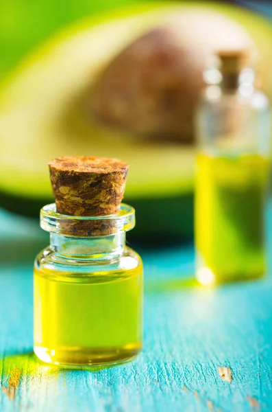 avocado oil cosmetics medicine health nature glass vial wooden background
