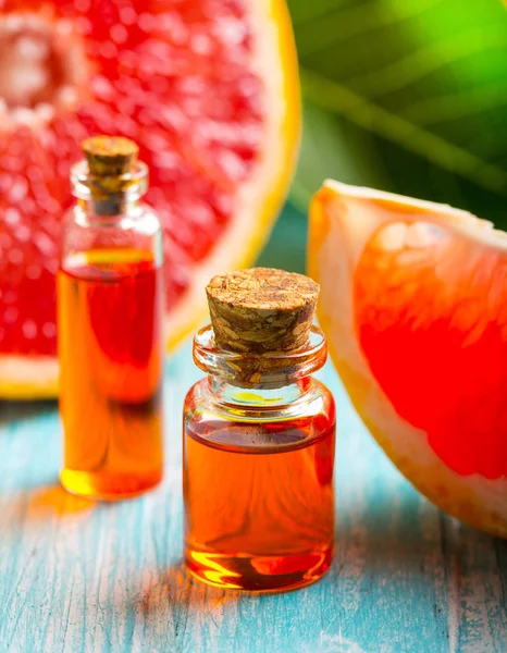 citrus oil cosmetic grapefruit medicine health nature glass vial wooden background