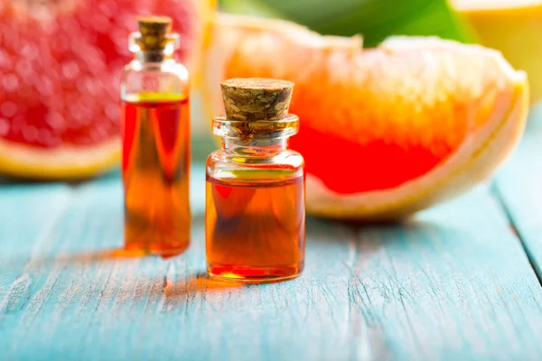 citrus oil cosmetic grapefruit medicine health nature glass vial wooden background