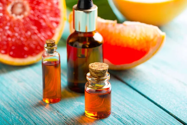 citrus oil cosmetic grapefruit medicine health nature glass vial wooden background