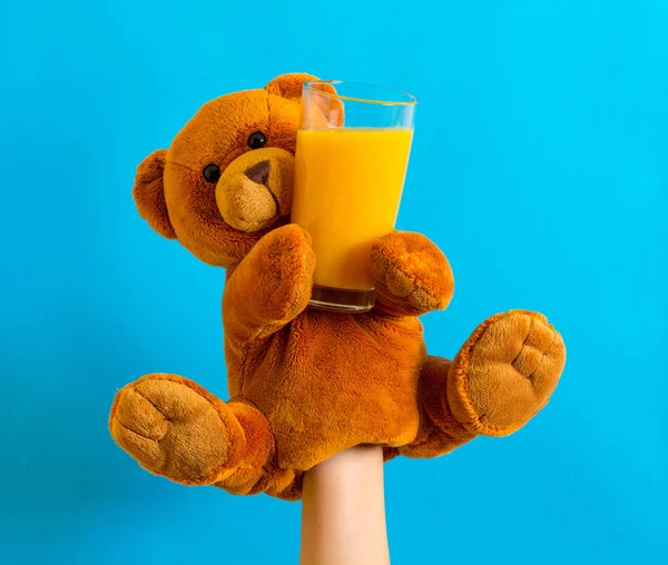 Orange juice cocktail children Hand puppet toy bear with hand inside Child play food drink