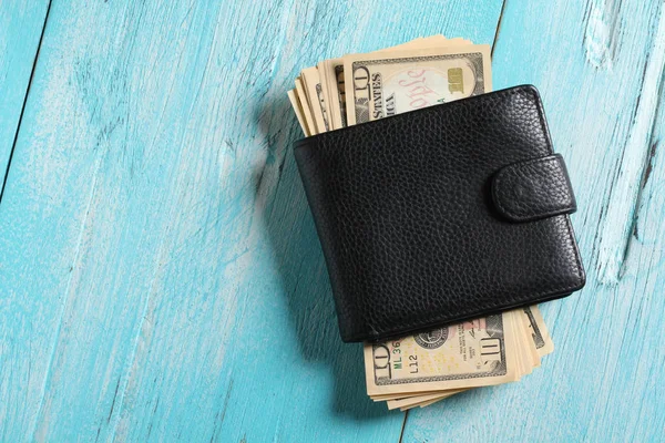 men\'s black wallet money in cash wooden white vintage background