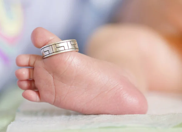 baby feet finger ring concept tenderness care mom dad love (macro)