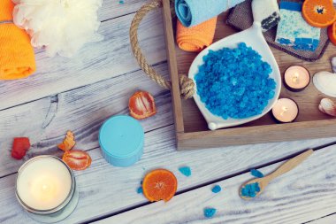 Spa oluşur mavi deniz tuzu, havlu, sabun, mumlar ve mandalina içinde ahşap tepsi
