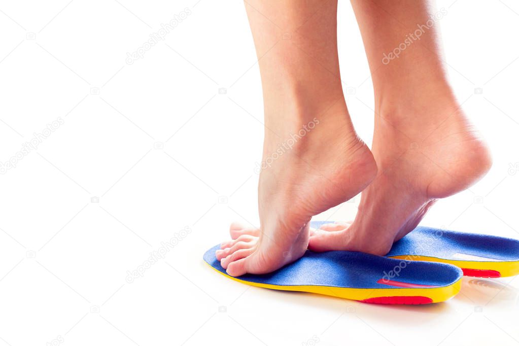 female feet stand on tiptoe in orthopedic insoles