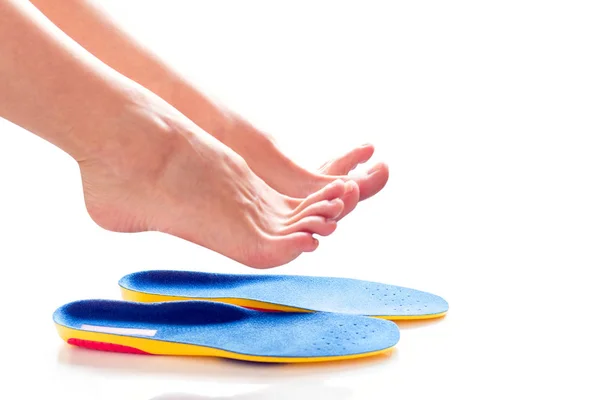 Orthopedic insoles and female legs — Stock Photo, Image