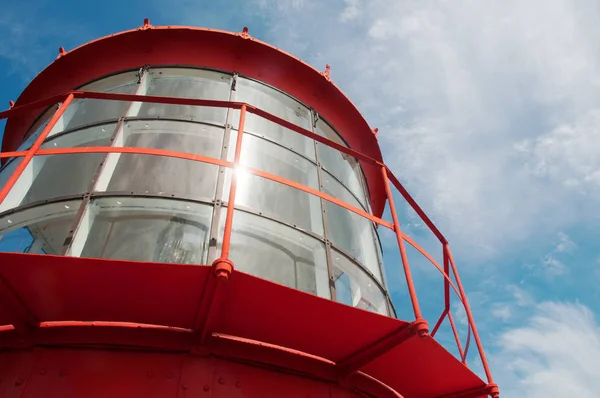 Close-up of a red lighthouse light with a blue sky in the background Royalty Free Stock Images