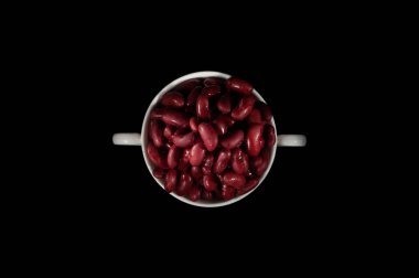 Beyaz fincan dolu siyah bir arka plan üzerinde izole barbunya