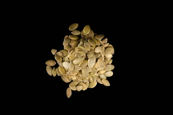 Small pile of seeds isolated on a black background — Stock Photo, Image