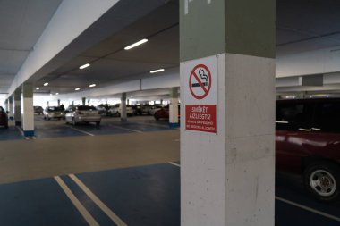 Kırmızı No sigara allower bir yer altı otoparkı araba arka planda görünür ile üç dilde oturum açmak