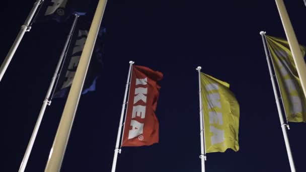 Riga, Letonya-3 Nisan 2019: IKEA bayrakları karanlık akşam ve rüzgar sırasında-arka planda mavi gökyüzü — Stok video