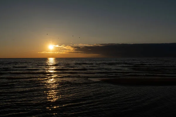 Puesta de sol vívida con sol muy bajo en el Mar Báltico - Colores rojos - Tuja, Letonia - 13 de abril de 2019 — Foto de Stock