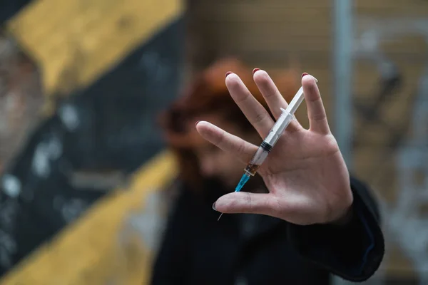 Hold syringe in hand in protest - Drug addict young redhead woman thinking about meaning of life - Depression and anxiety — Stock Photo, Image