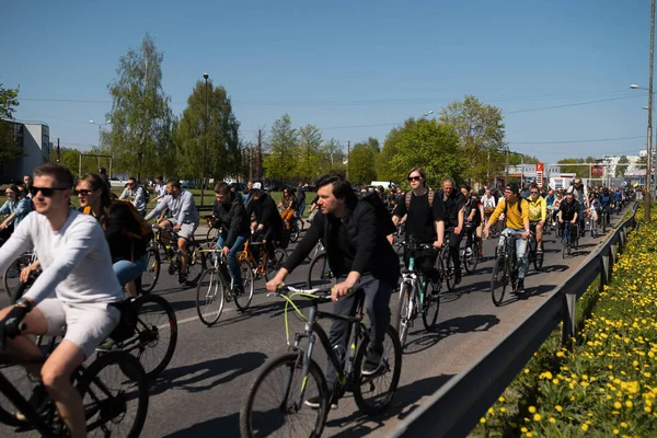 Riga, Letonya - 1 Mayıs 2019: Diğer arabalar ve trafik ile kamusal alan yolda aileler ve arkadaşlar ile İşçi Günü Bisiklet geçit töreni