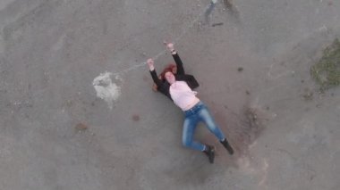 Bir ceket ile mavi kot pantolon ve pembe t-shirt giyen bayrak gösteren aktris gibi hareket Chained kapana kısılmış kadın kavramı Anten - Kafkas beyaz kızıl kız - Yukarıdan üstten görünümü
