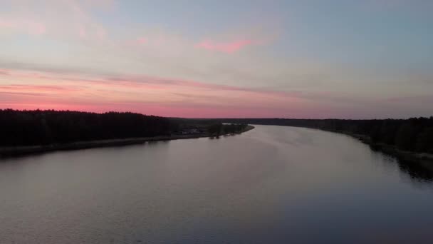 Верхний вид с воздуха пролетает над рекой Лиелупе в Юрмале, Латвия Весна 2019 года во время восхода солнца с багровым фиолетовым и розовым небом - Солнце почти не видно — стоковое видео