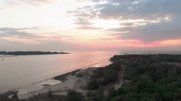 Aerial Lighthouse epic cinematic shot with very little clouds and warm dusk - Drone view from above river enters Baltic Sea gulf - Smooth professional nd filter movement — Stock Video